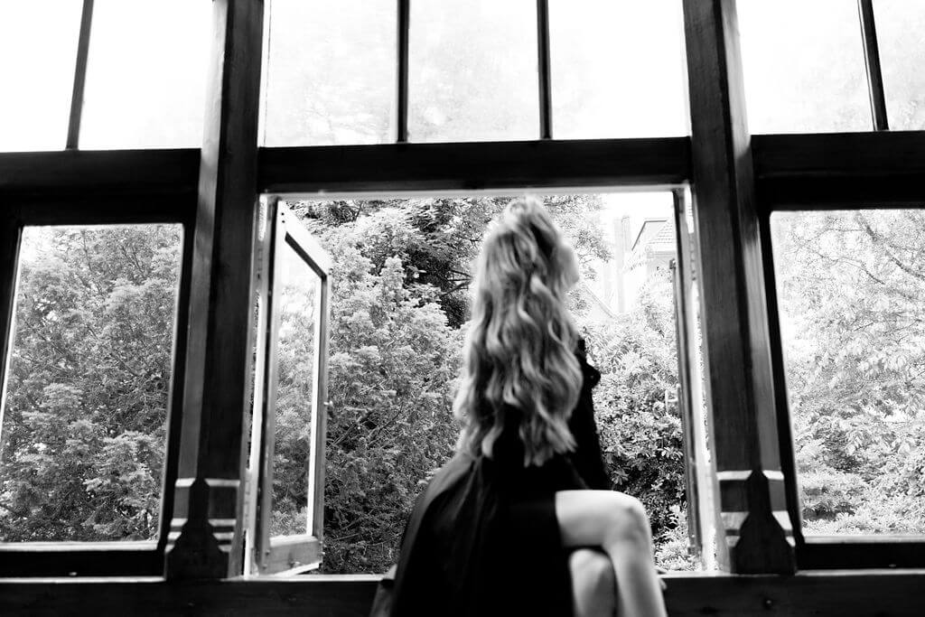 Daria Lazko photographed at 36 in a studio in Amsterdam, wooden window frame in the background.